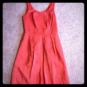 Coral, sleeveless dress with belts loops.